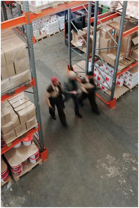 Blurred motion of workers managing inventory in a