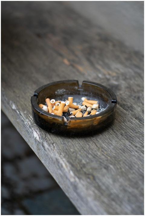 Detailed view of an ashtray filled with cigarette