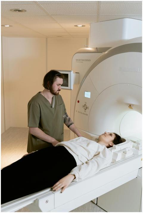 A healthcare worker assists a patient during an MR
