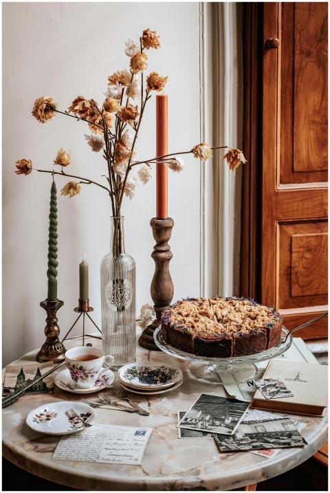A cozy autumn still life with cake, candles, and p