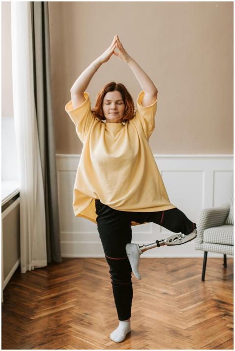 Woman practicing yoga indoors, showcasing balance