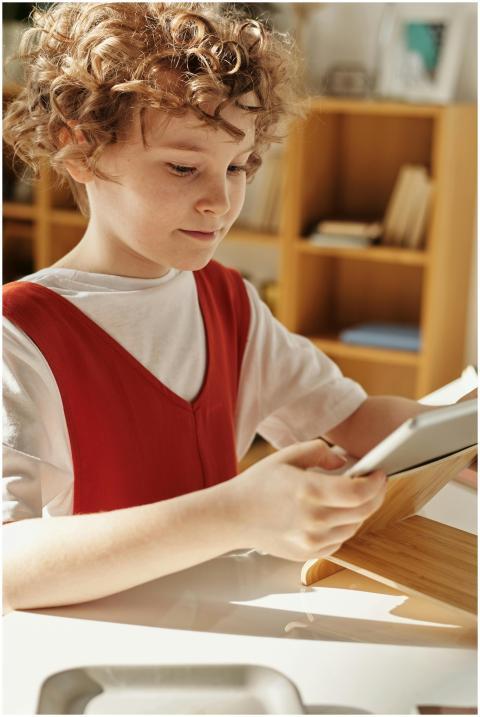 Young child using a tablet for distance learning a