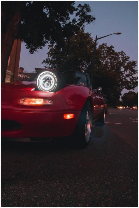 Low angle shot of a red convertible with headlight