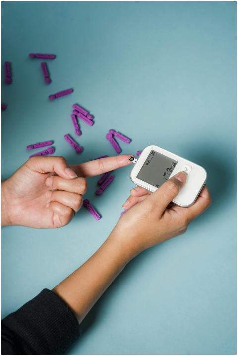 From above of crop anonymous female diabetic using