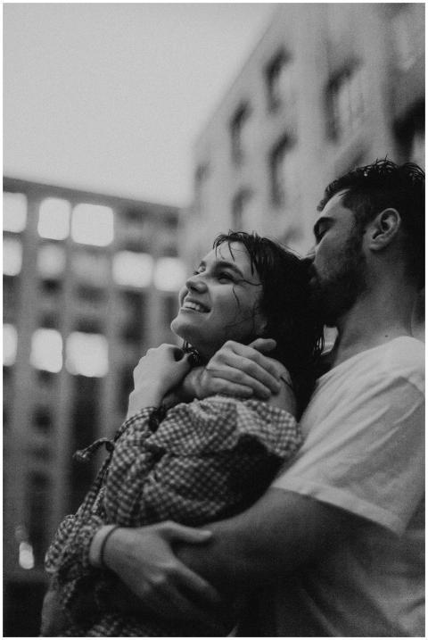 Black and white photo of a couple embracing joyful