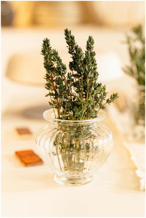 A close-up of fresh thyme sprigs in a decorative g