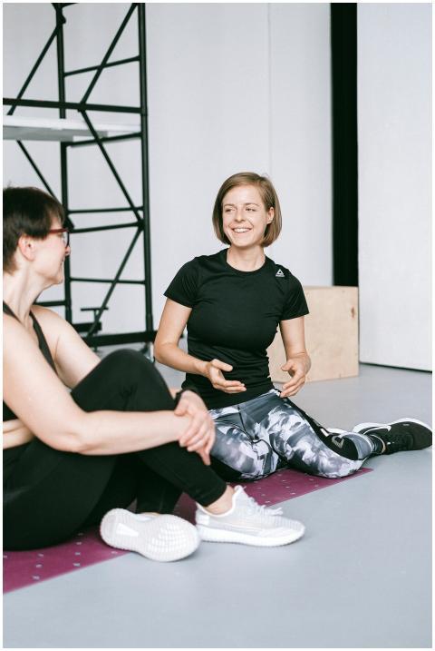 Two women in sportswear having a conversation indo
