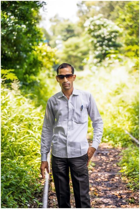 A man in sunglasses stands confidently on an overg