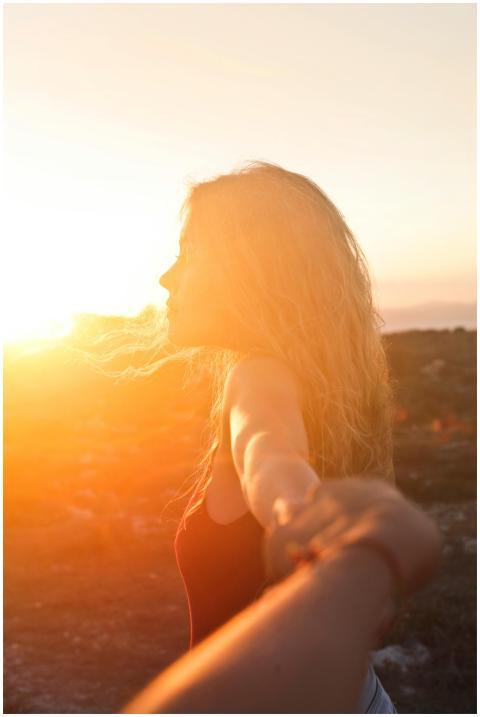 A woman enjoys a serene moment in Malta's golden s