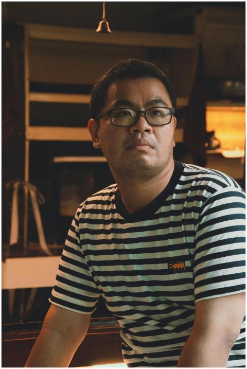 Indoor portrait of a man with glasses wearing a st