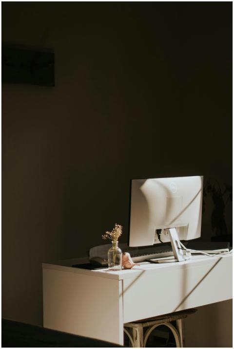 A serene, minimalist home office with a sleek moni