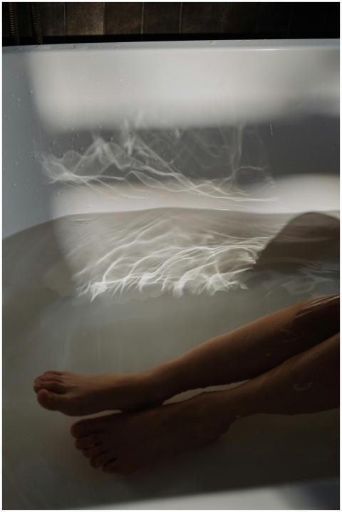 A soothing bath scene with legs submerged, showcas