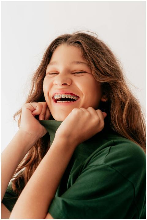 Joyful portrait of a teenage girl in a green shirt