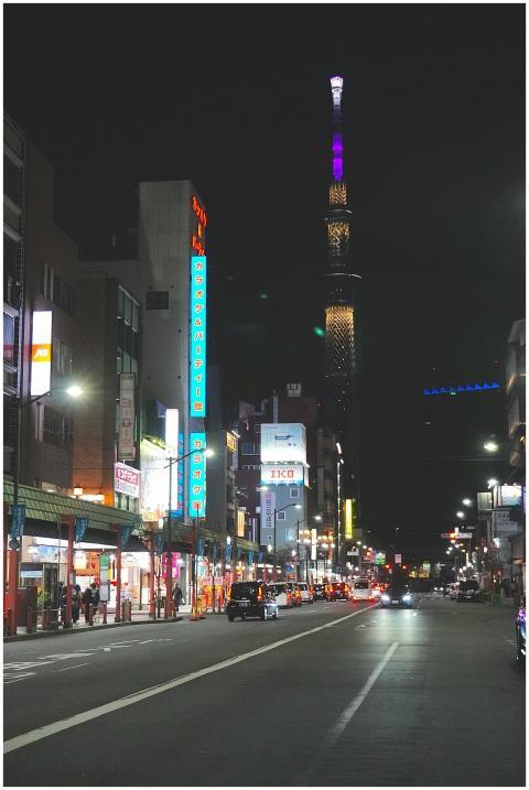 Vibrant night view of a bustling Tokyo street with