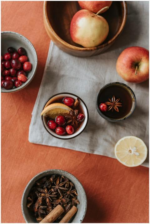 Warm flat lay of mulled wine ingredients with appl