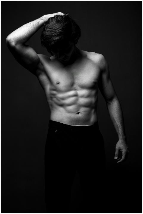 Artistic black and white photograph of a shirtless
