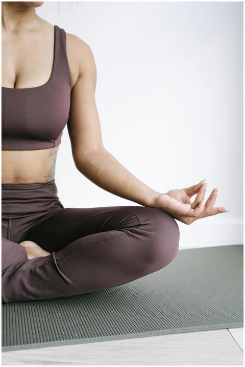 A woman practicing yoga meditation in activewear,