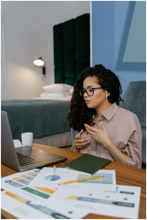 Young woman participating in an online meeting fro