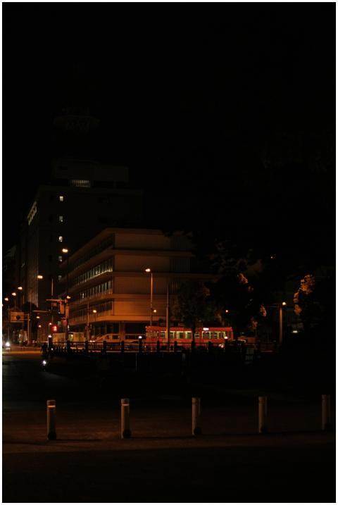 Urban night scene featuring city buildings and str
