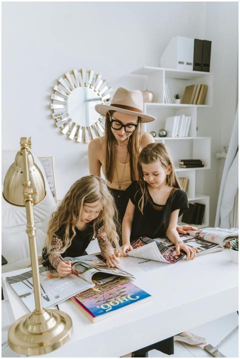 A mother and her two daughters enjoy reading magaz