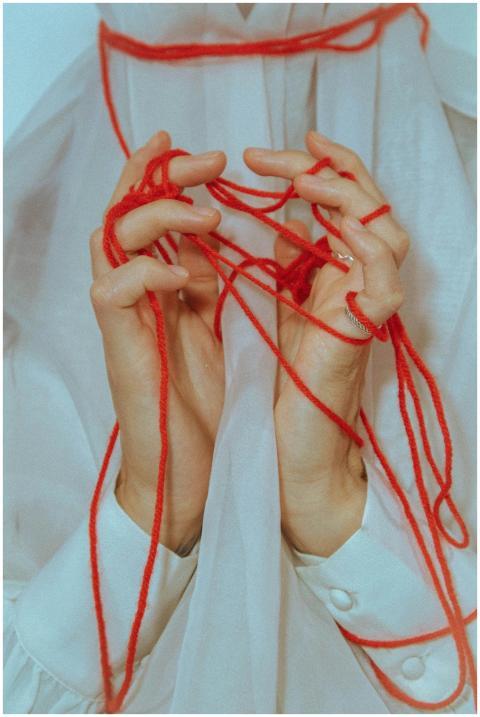 An artistic depiction of hands tangled in vibrant