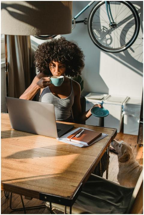 African American woman working from home with lapt