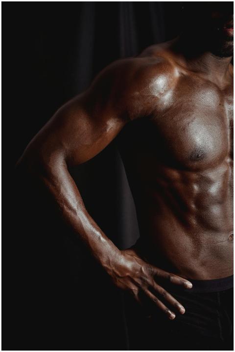 Close-up of a muscular, shirtless male torso highl