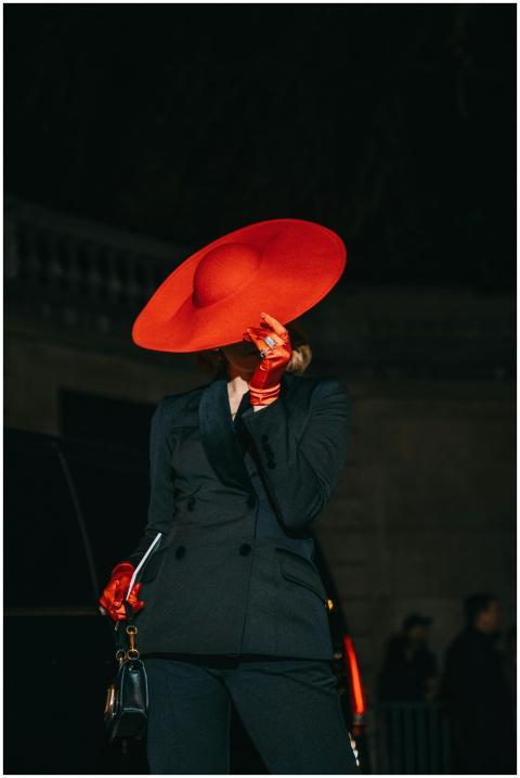 Fashionable woman in large red hat and gloves, sty