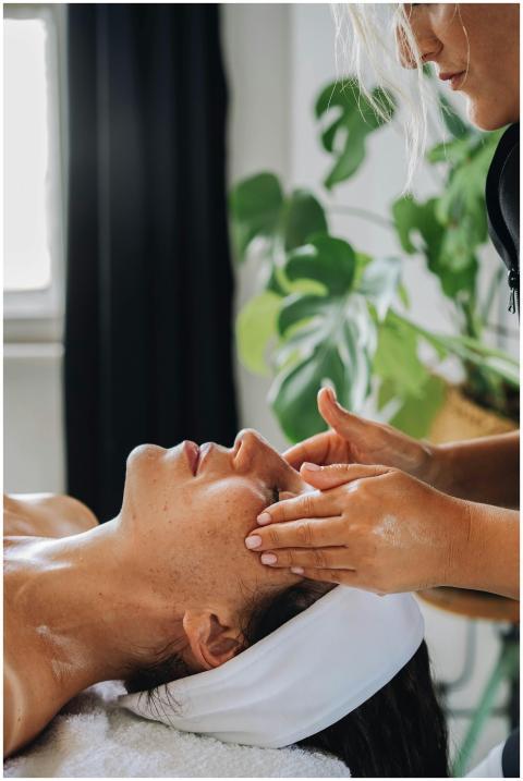 Woman receiving a calming facial massage at a well
