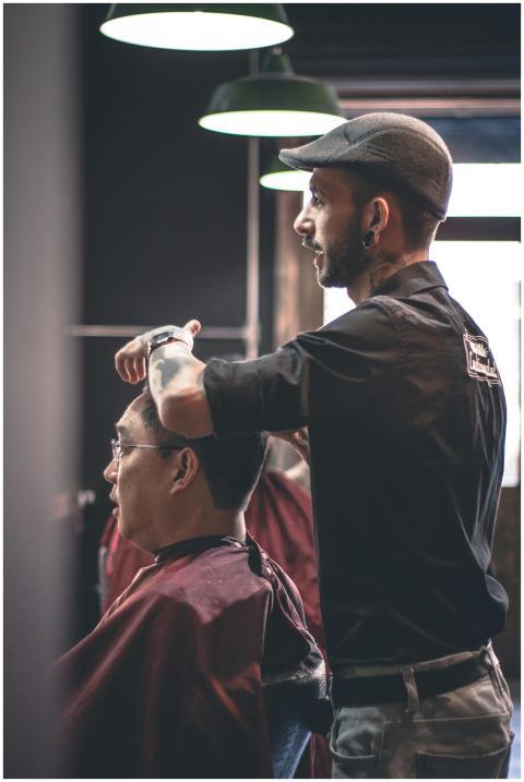Barber skillfully trims customer's hair in a moder
