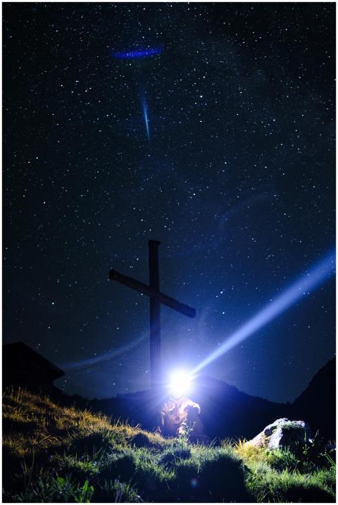 A serene starry night capturing an illuminated cro