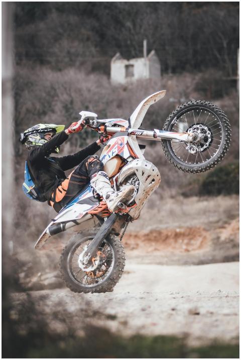 A thrilling dirt bike stunt captured outdoors, sho
