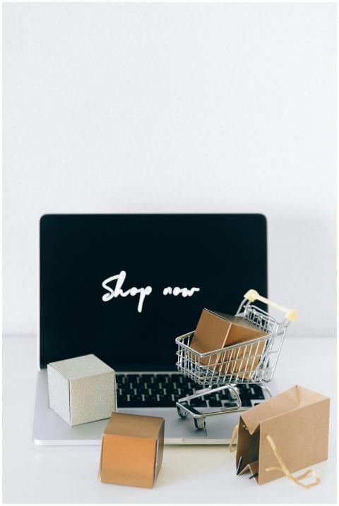 Minimalist online shopping setup with laptop, cart