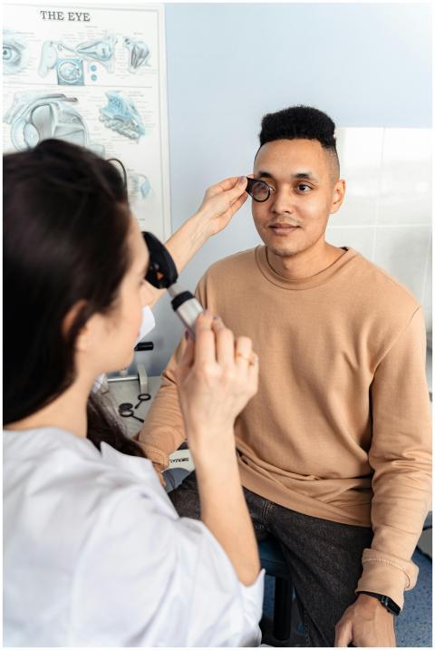 Optometrist conducting eye examination on patient