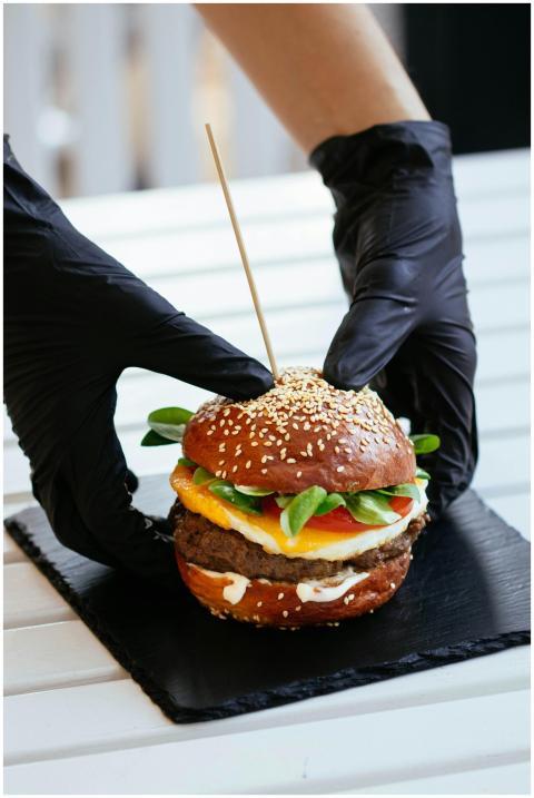 A delicious gourmet burger with sesame bun and fre