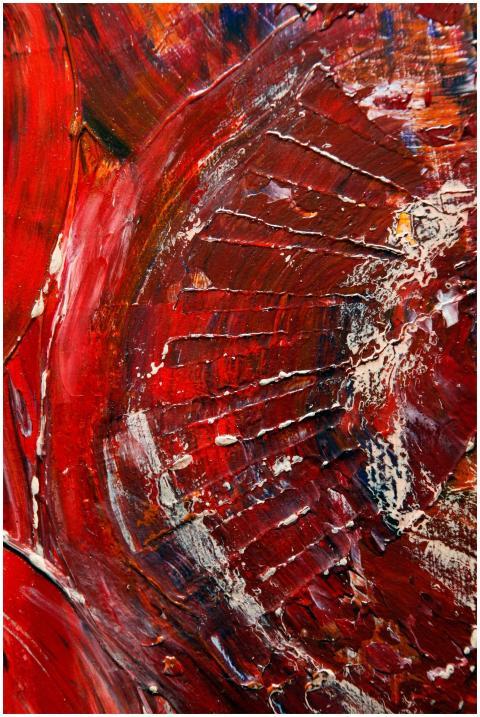 Dynamic abstract artwork in red hues with textured