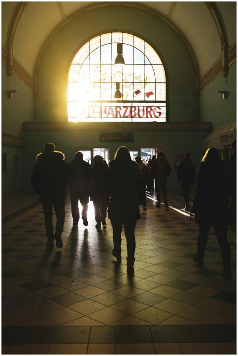 People walking through Bad Harzburg station at sun