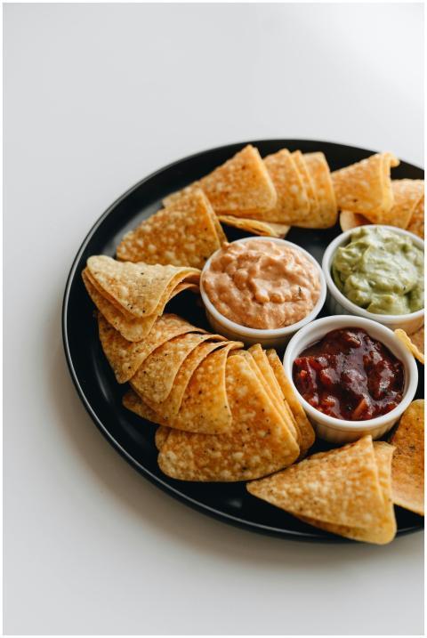 Appetizing nachos served with guacamole, salsa, an