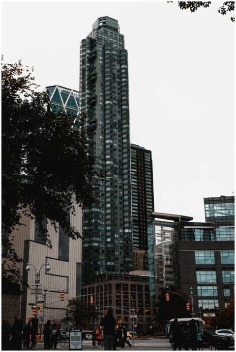 A towering modern skyscraper set against an urban