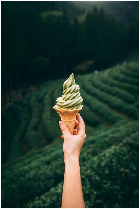 Close-up of a matcha ice cream cone held in front