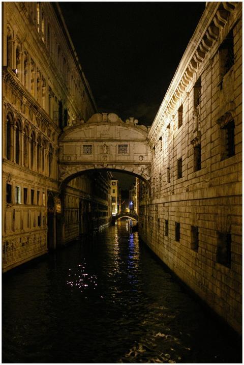 A nocturnal view of the Bridge of Sighs over a Ven