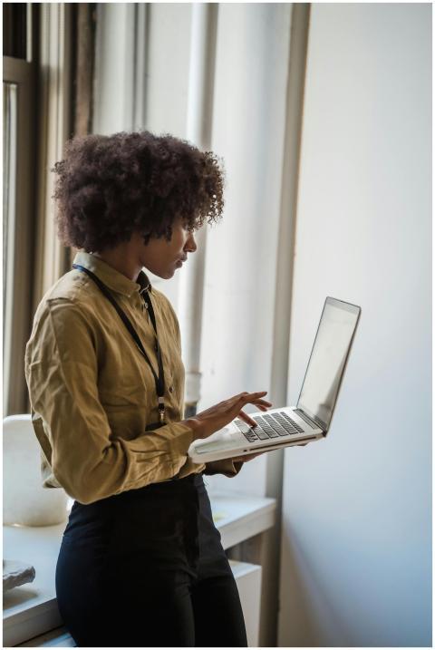 Side profile of a businesswoman using a laptop in
