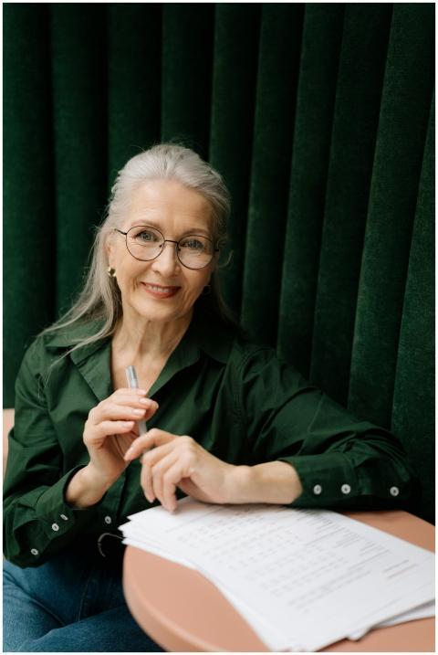 Elegant senior woman with eyeglasses smiling while