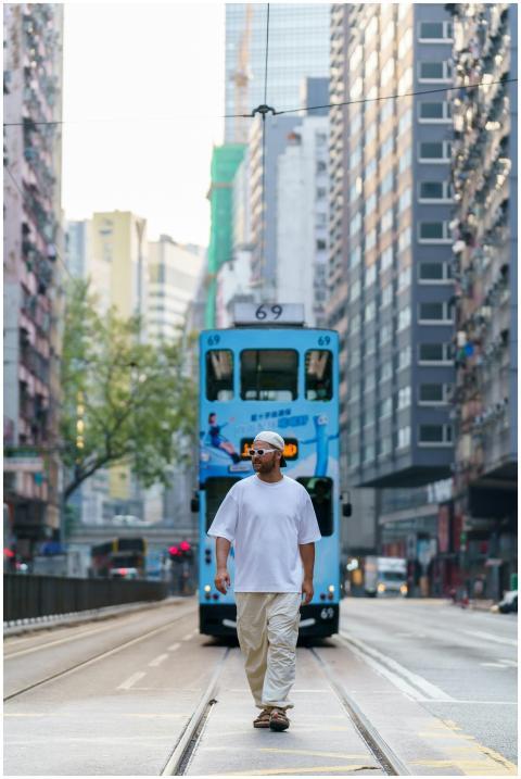 A man walks confidently on the streets of Hong Kon