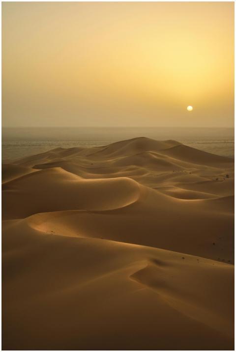 Peaceful sunrise illuminating the vast sand dunes