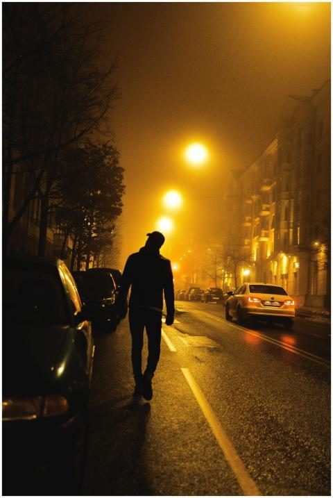 A mysterious silhouette walks along an illuminated