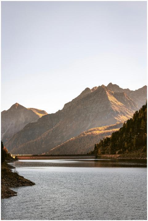 Peaceful lakeside view with majestic mountain back