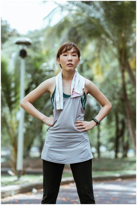 Young Asian sportswoman taking a break after runni