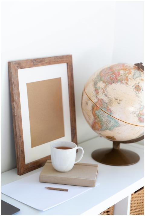 A serene home office setup featuring a globe, fram