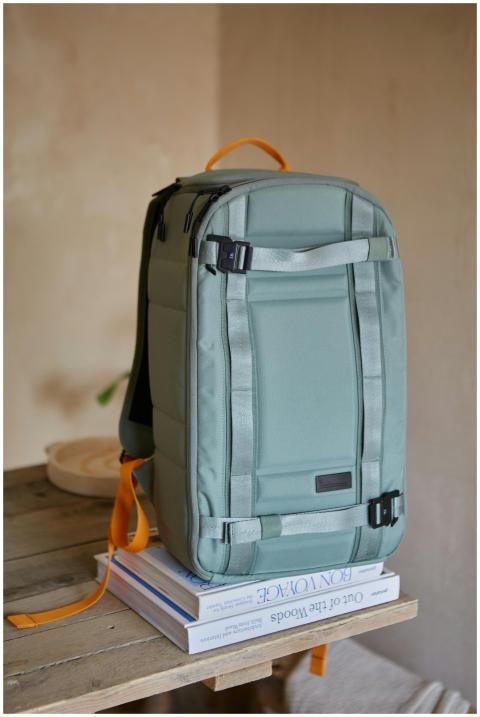 A contemporary backpack on a wooden table indoors,